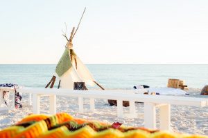 Beach side Bohemian bonfire setting by Ceremony Design Company. Photograph by Mad Love Weddings. 